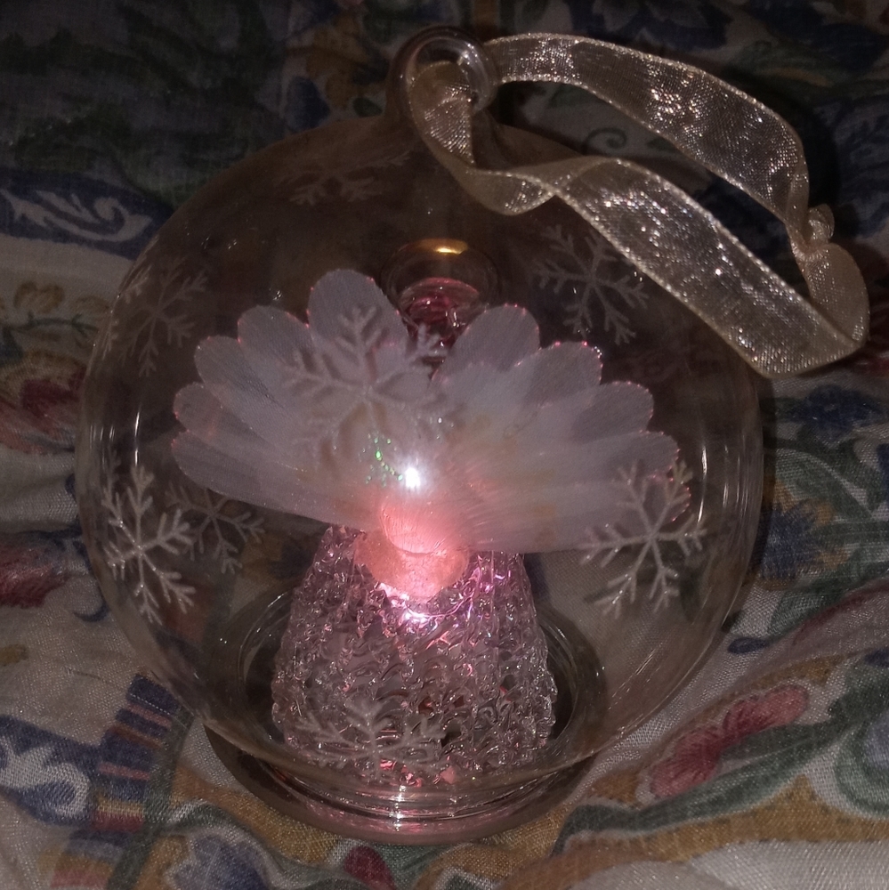Vintage hanging Ornament, Snowflake on globe enveloping a Fiber Optic Angel